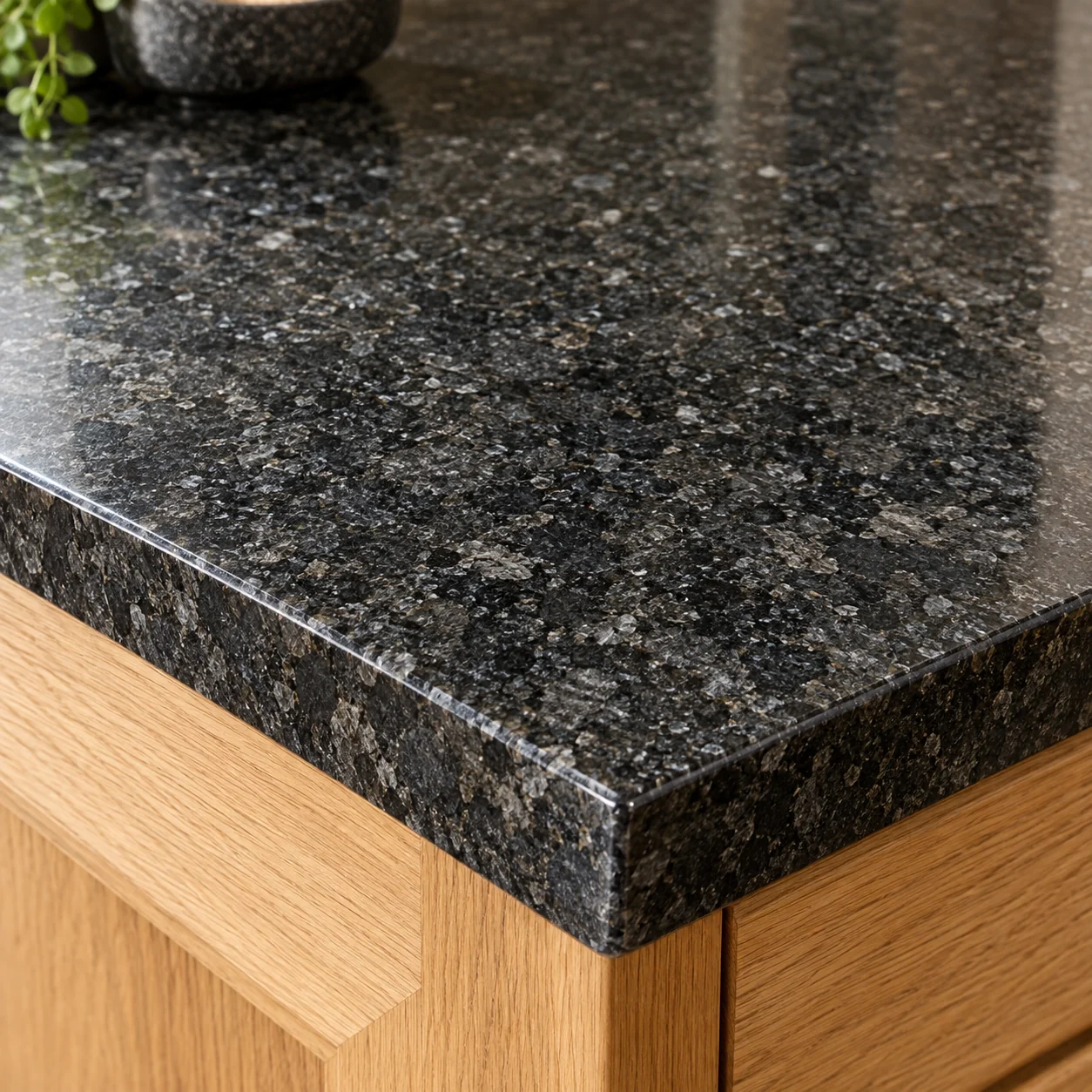 Dark granite worktop with natural crystalline speckles and a polished edge